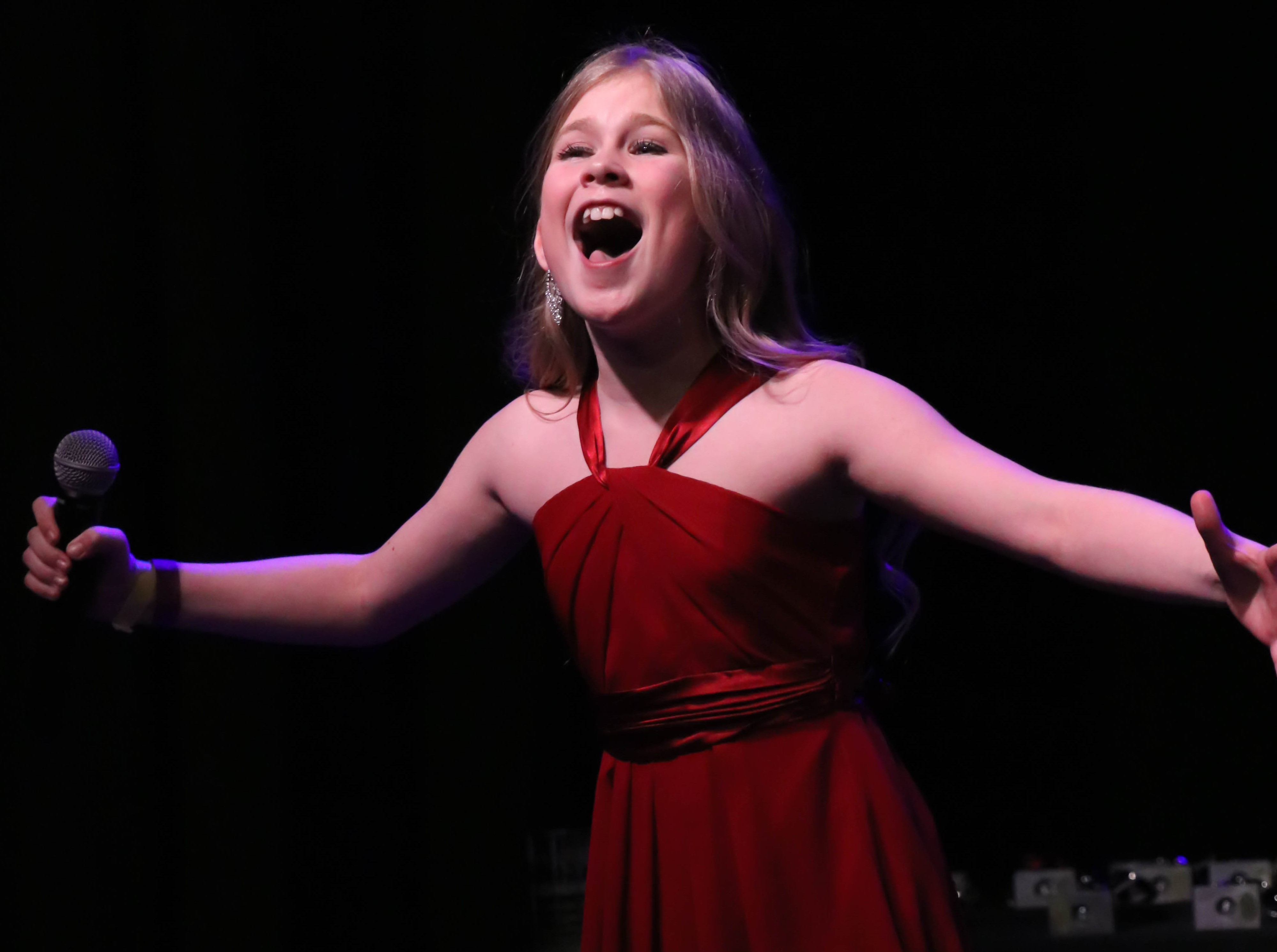 A picture of an North Texas Performing Arts student performing on stage.