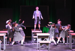 Actors performing Revolting Children in Matilda